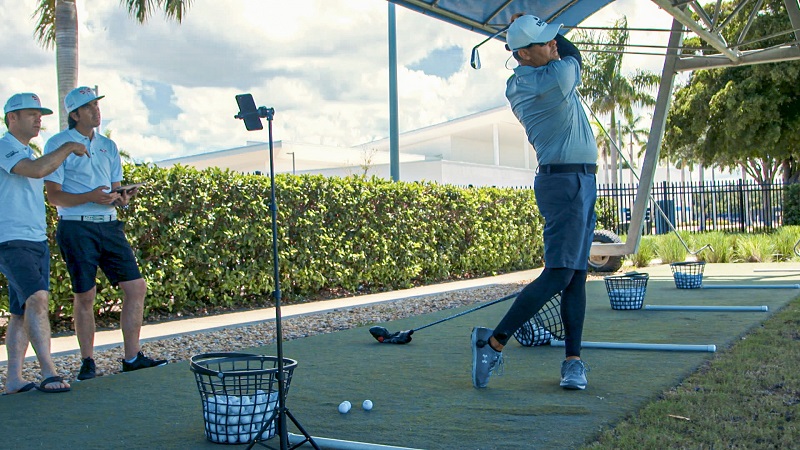 An Image Of Senior Golf Coach In Practice Session With His Students.